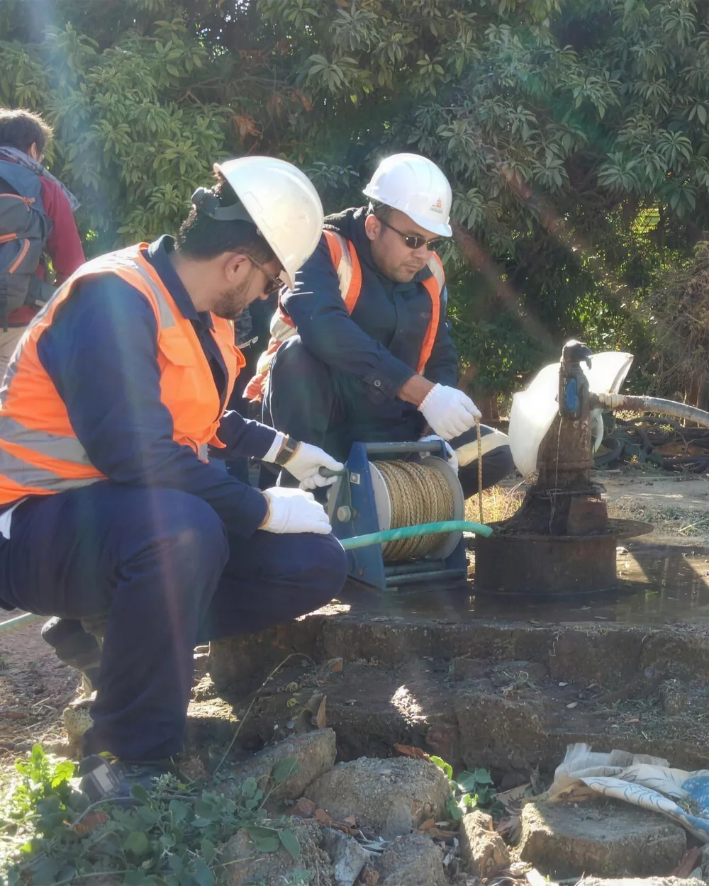 Field team sampling groundwater at a farm wellhead
